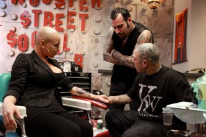 Tommy Montoya and Robear Chinosi talk over Ashley Eliese tattoo.